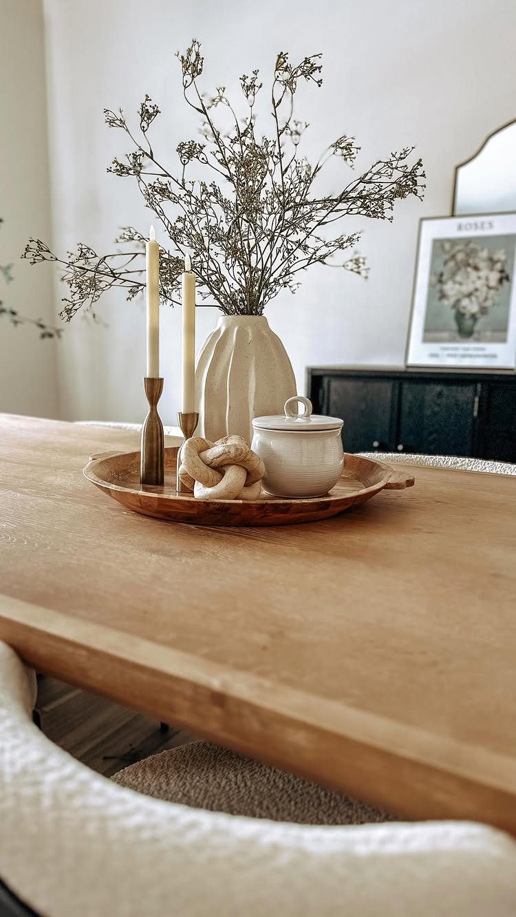 15 Dining Room Decor Modern Ideas with Style and Function 5 Wooden dining table centerpiece with dried branches in a vase and cream candles.
