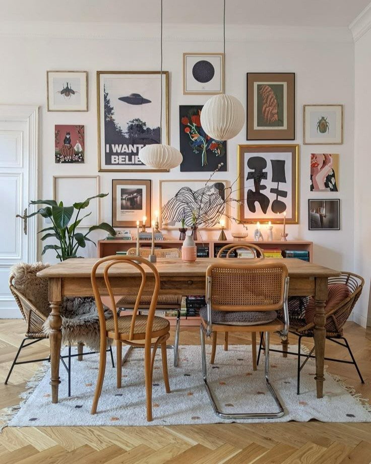 10 Dining Room Decorating Ideas for 2027 That Feel Fresh 9 Dining room with mismatched chairs, a wooden table, and a gallery wall of art.