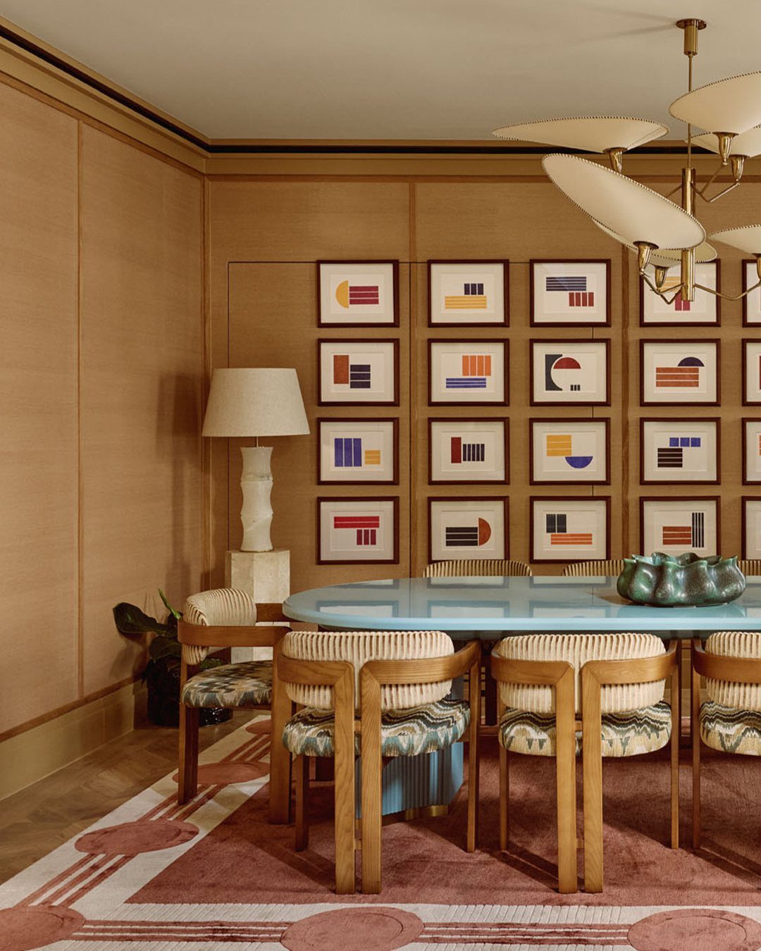 10 Dining Room Decorating Ideas for 2027 That Feel Fresh 5 High-gloss blue lacquered dining table surrounded by wooden chairs in a modern room.
