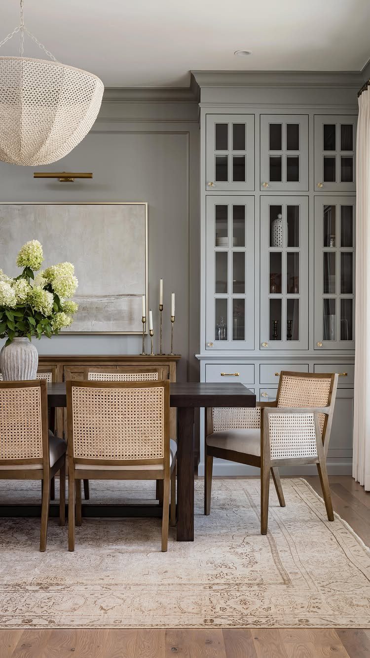 10 Dining Room Decorating Ideas for 2027 That Feel Fresh 1 Woven sculptural pendant light hanging over a dark wood dining table and cane chairs.