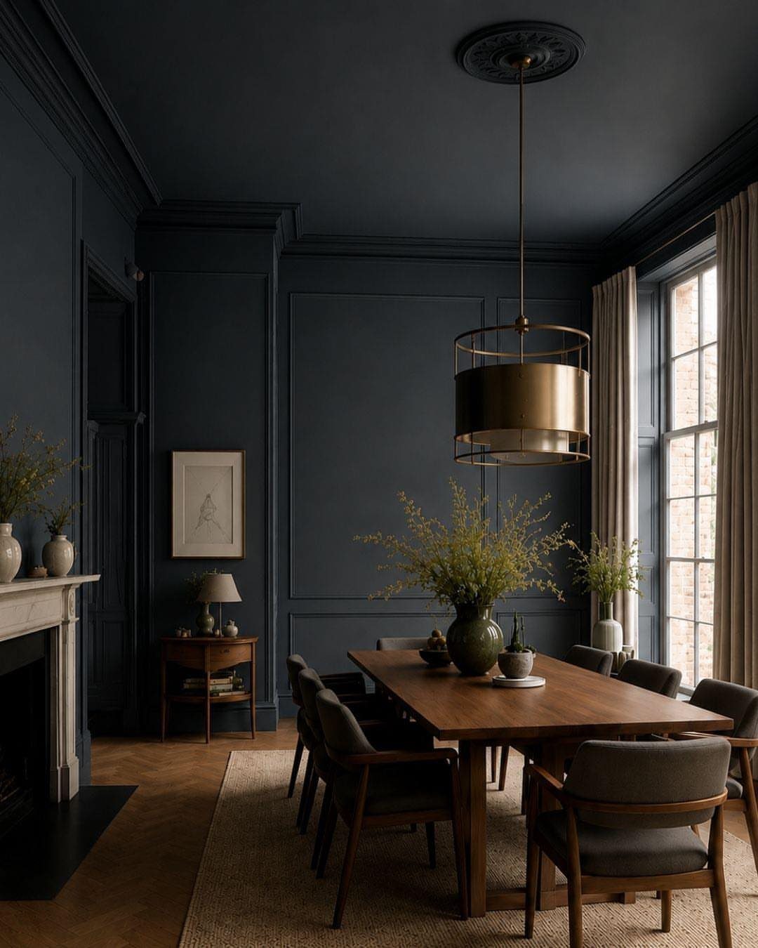 10 Dining Room Grey Wall Ideas for a Refined Look 2 Dark grey dining room with wooden table, brass light, and jute rug.