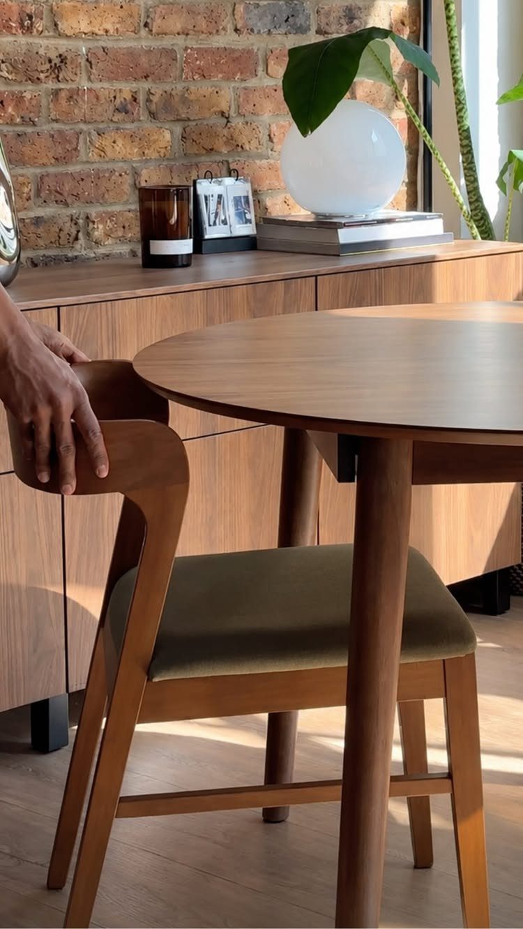 Dining Room Mid Century Ideas: 6 Ways to Style Your Space 4 Mid-century modern dining room with round wooden table, green chair, and brick wall.