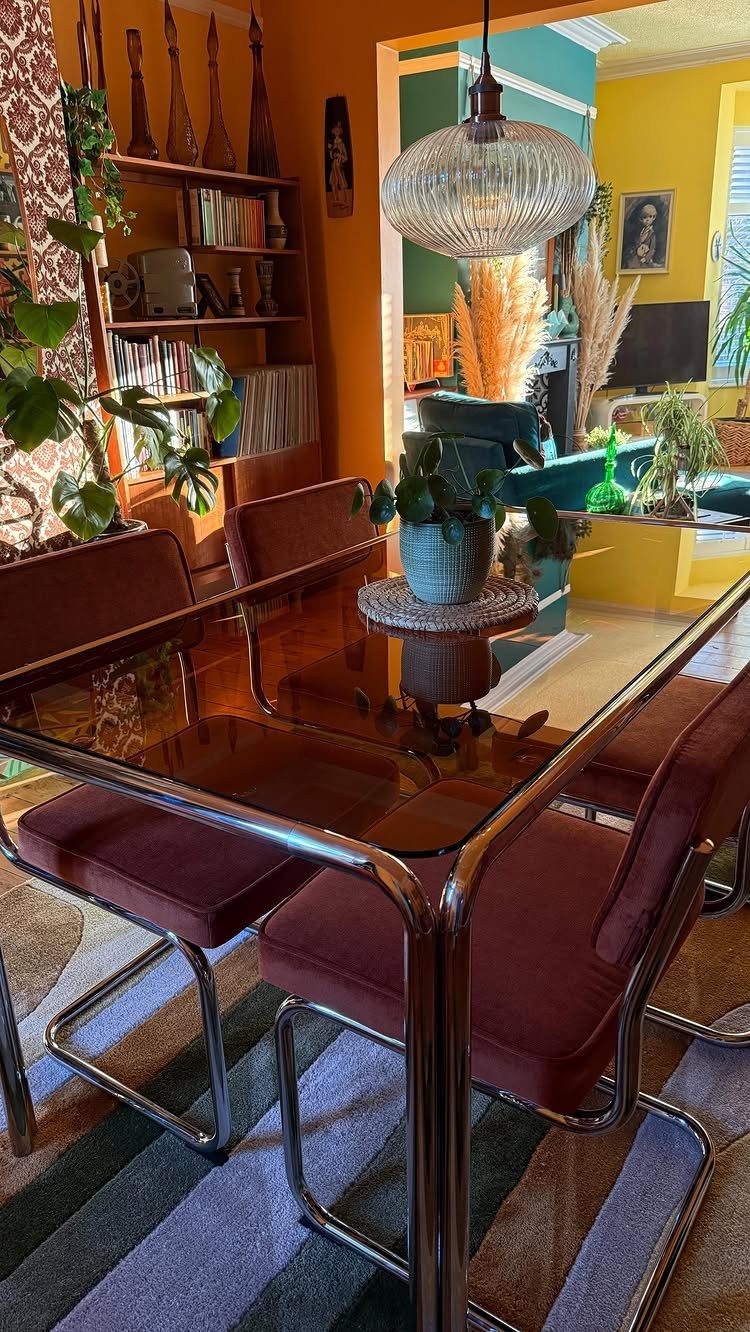 Dining Room Mid Century Ideas: 6 Ways to Style Your Space 6 Mid-century modern dining room with glass table, burgundy chairs, and orange walls.
