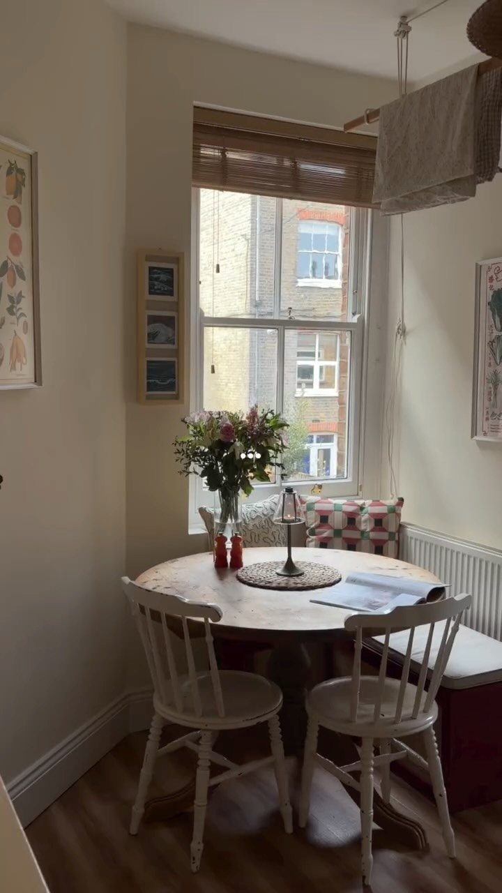 7 Dining Room Table Ideas for a Standout Space 5 Round wooden dining table with white chairs and a cushioned bench seat