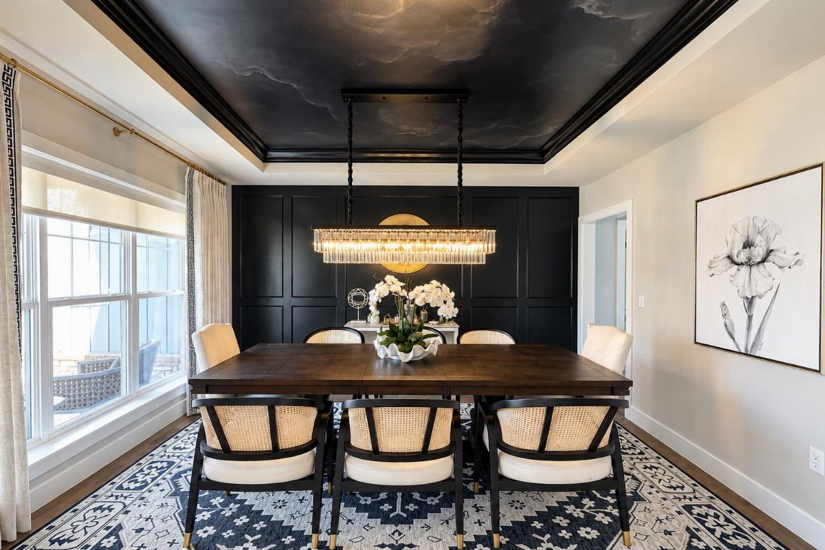 11 Dining Room Tray Ceiling Ideas with Photos 9 Dining room with a dark patterned tray ceiling and a linear gold chandelier.