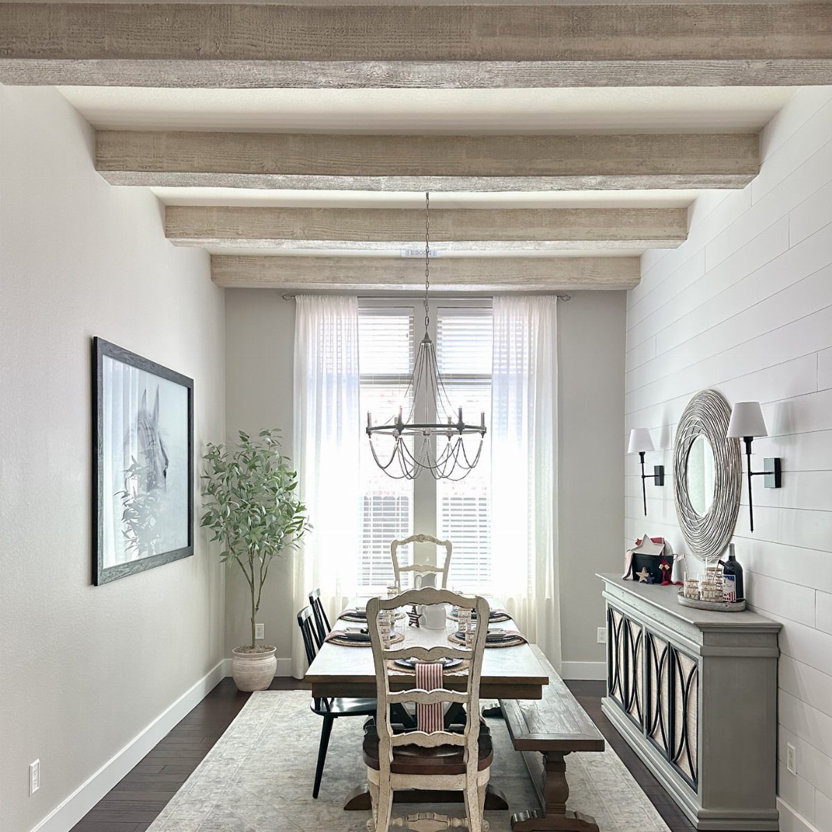 11 Dining Room Tray Ceiling Ideas with Photos 5 Dining room with light wood exposed beams on the ceiling and a chandelier.