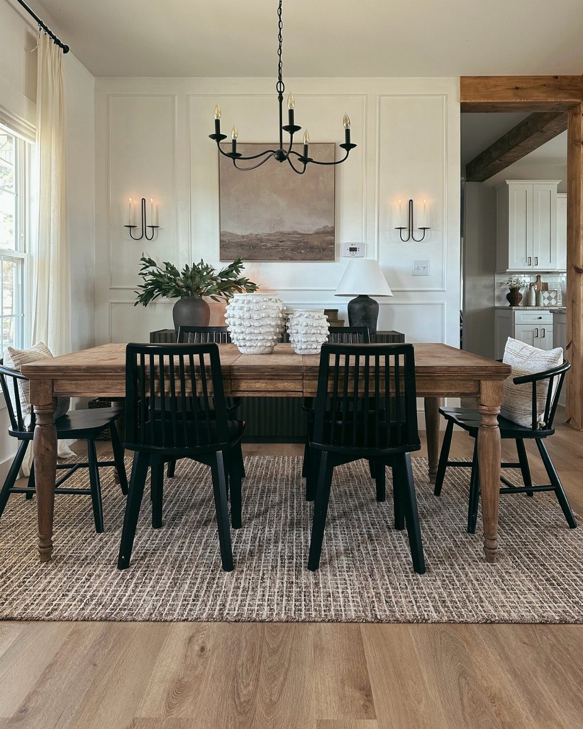 5 Dining Room with Carpet Ideas to Refresh Your Space 4 Wooden dining table and black chairs on a beige rug over hardwood floors.