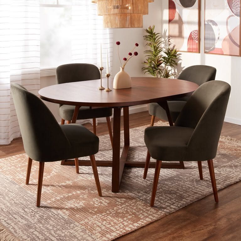 8 Dining Tables for Dark Wood Floors That Work 2 Round dark wood dining table and green chairs on a patterned area rug.