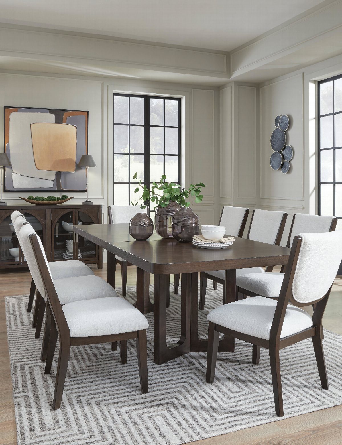 8 Dining Tables for Dark Wood Floors That Work 4 Dark brown wooden dining table with white upholstered chairs on a patterned rug