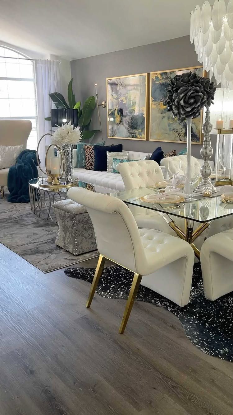 10 Dining Table in Living Room Ideas for Small Spaces 3 Glass dining table with white chairs set upon a dark blue textured area rug.