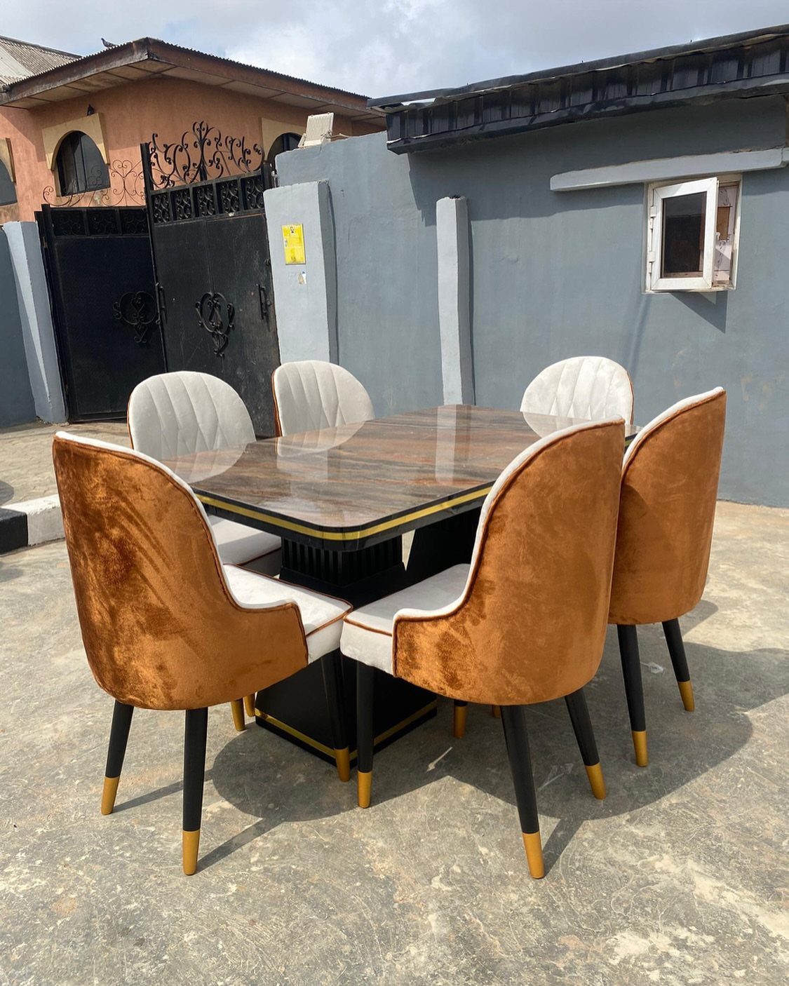 5 Dining Table Mixed Chairs Ideas That Work 1 Marble dining table with mixed tan and white upholstered chairs outdoors