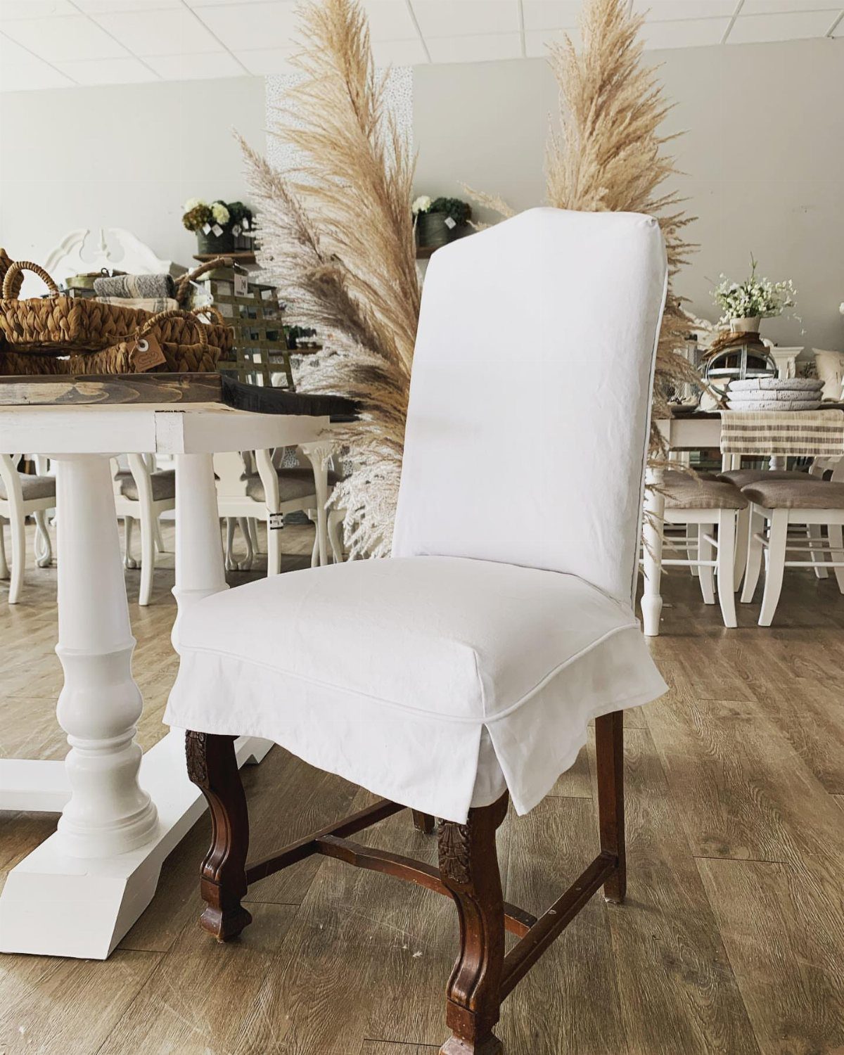 5 Dining Table Mixed Chairs Ideas That Work 5 Wooden dining chair with a white fabric slipcover in a bright room.