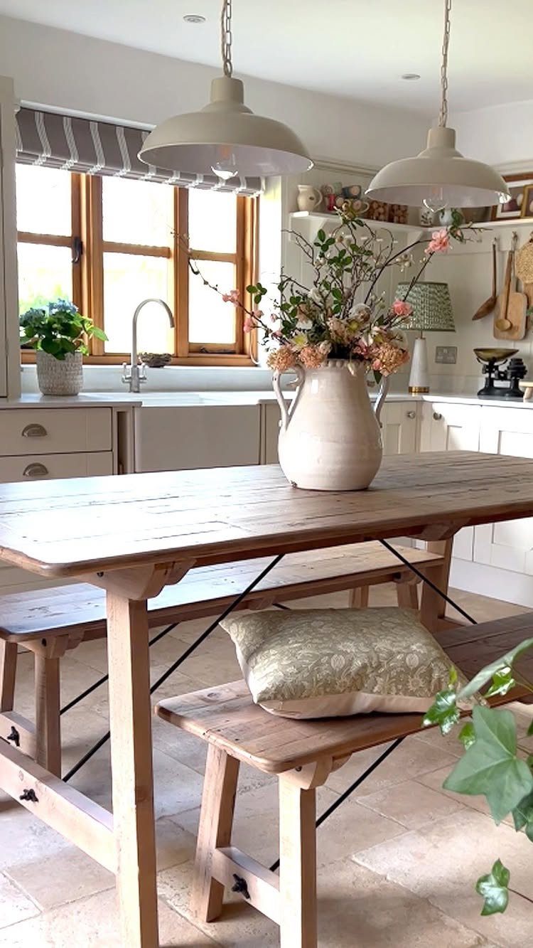 7 Dining Table with Mismatched Chairs Ideas That Work 2 Rustic wooden dining table with a matching wooden bench and floral centerpiece.
