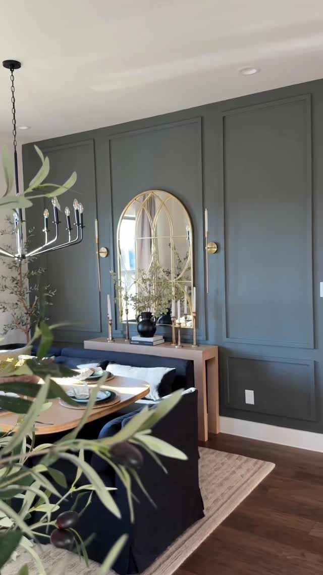 4 Evergreen Fog Dining Room Ideas with Photos 4 Dining room with evergreen fog green paneled walls, gold arched mirror, and blue seating.