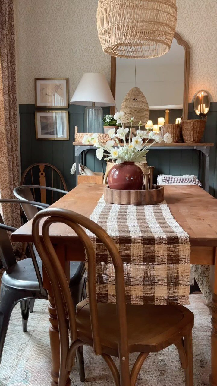 9 Farmhouse Style Dining Room Ideas with Photos 4 Wooden dining table with plaid runner and bentwood chairs in a rustic room.