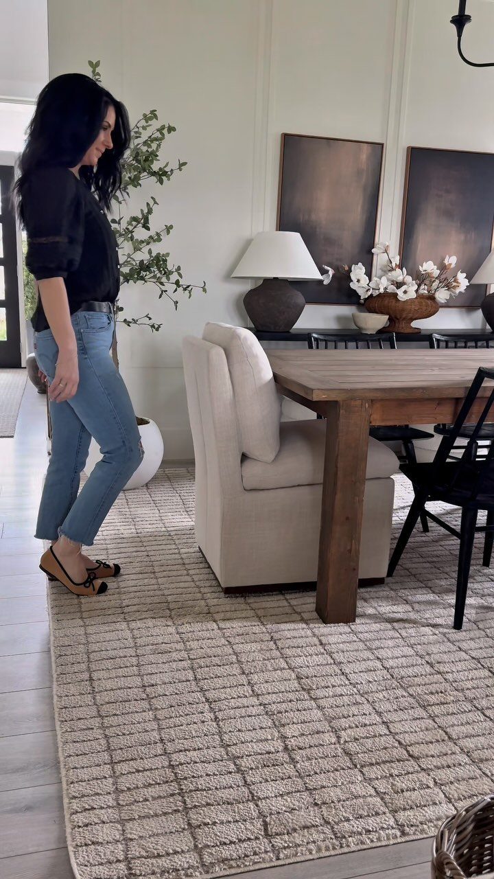 9 Farmhouse Style Dining Room Ideas with Photos 1 Dining room with a wooden table, cream upholstered chair, and black wooden chairs.