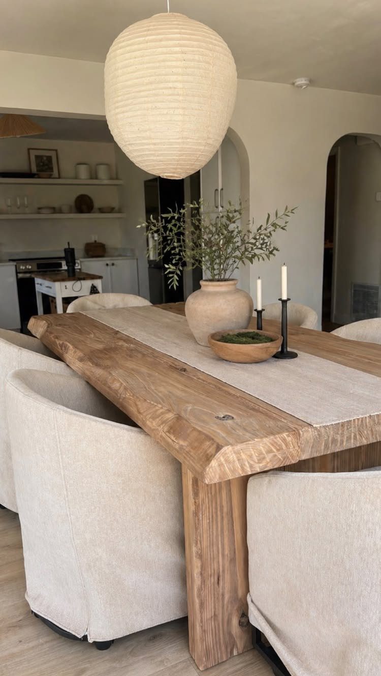 9 Farmhouse Style Dining Room Ideas with Photos 9 Rustic wooden dining table with cream slipcovered chairs and a large paper globe light.