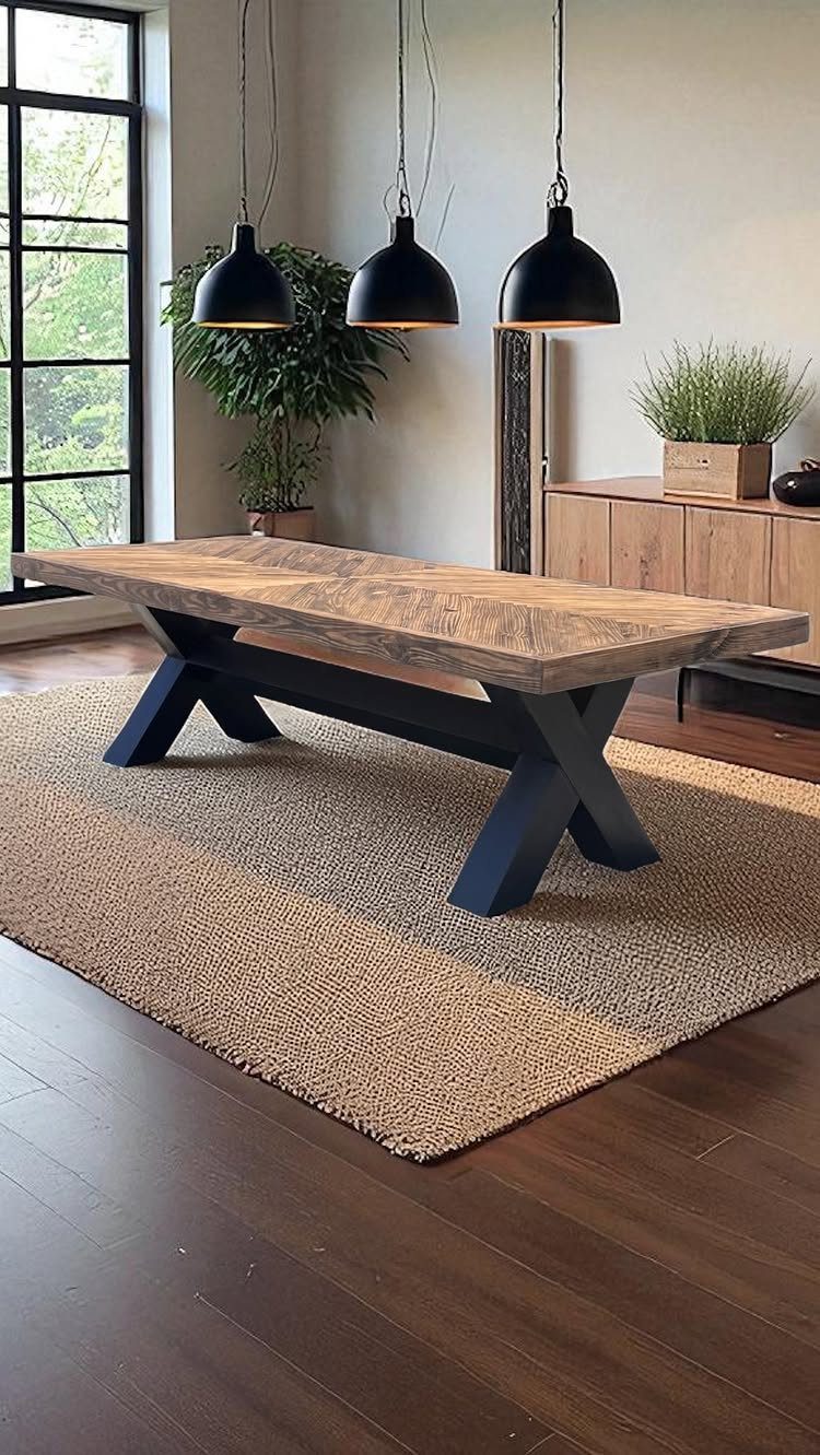 9 Farmhouse Style Dining Room Ideas with Photos 2 Rustic wooden dining table with black X-legs on a woven tan rug.