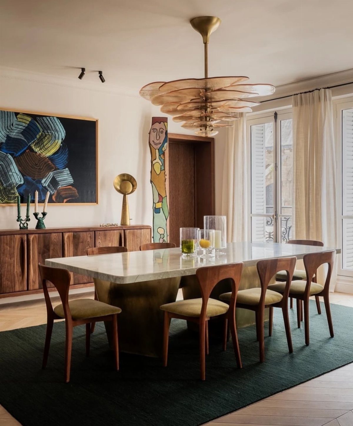 8 Feng Shui Dining Room Ideas for Balance and Flow 4 Modern dining room with marble table, gold lighting, and abstract wall art.