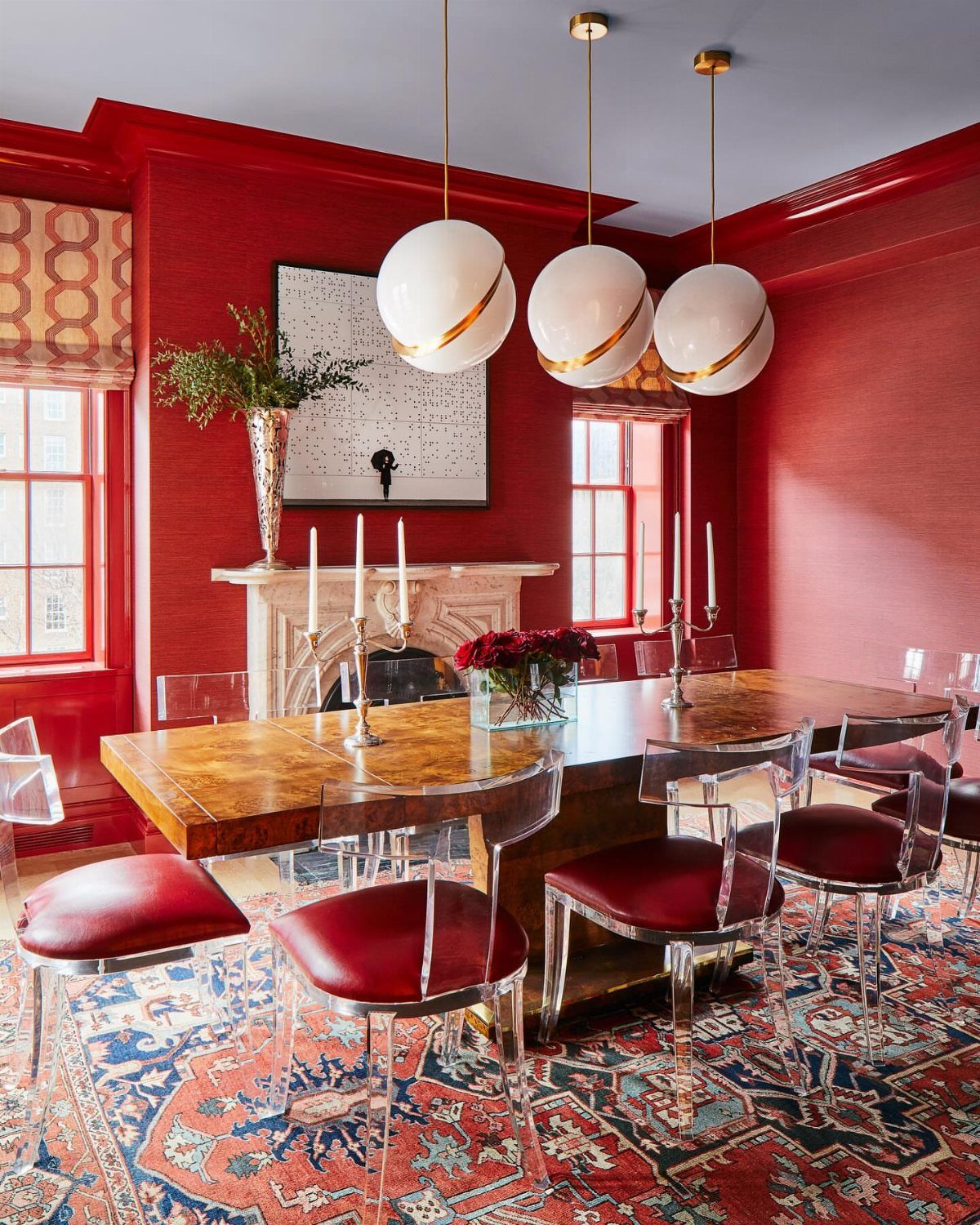 8 Feng Shui Dining Room Ideas for Balance and Flow 6 Dining room with red walls, wooden table, acrylic chairs, and spherical pendant lights.