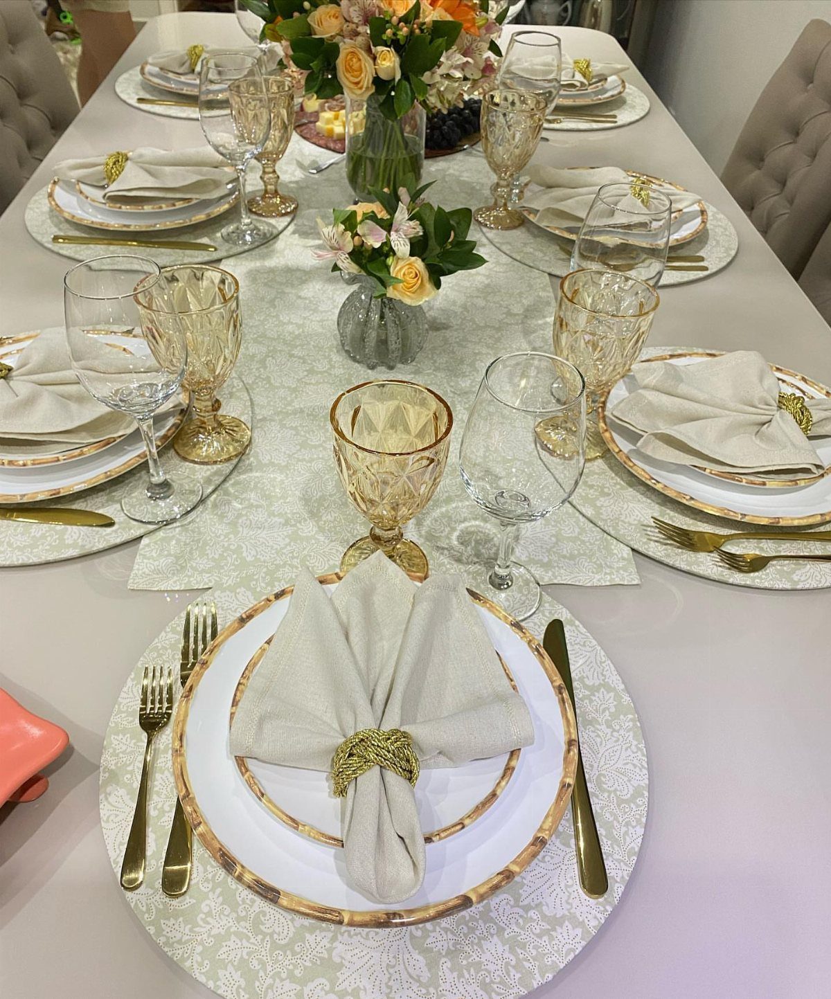 13 Formal Dining Room Ideas for an Elegant Space 5 Formal dining table set with gold-rimmed china, crystal glasses, and floral centerpieces.