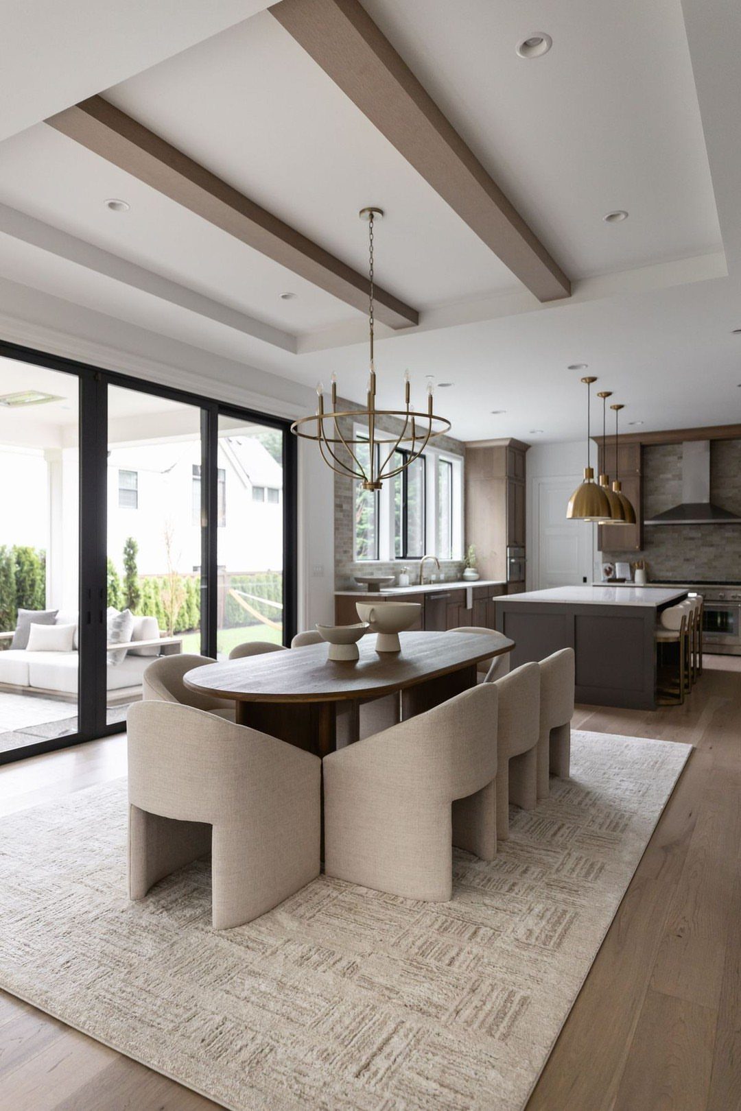 13 Formal Dining Room Ideas for an Elegant Space 13 Oval wooden dining table with cream chairs in an open-concept home layout.