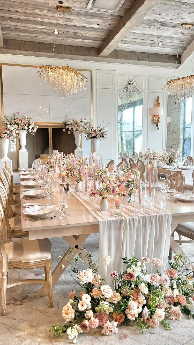 6 Formal Dining Table Decor Ideas for an Elegant Setting 5 Formal dining table with white runner, pink flowers, and tall glass cylinder candles.