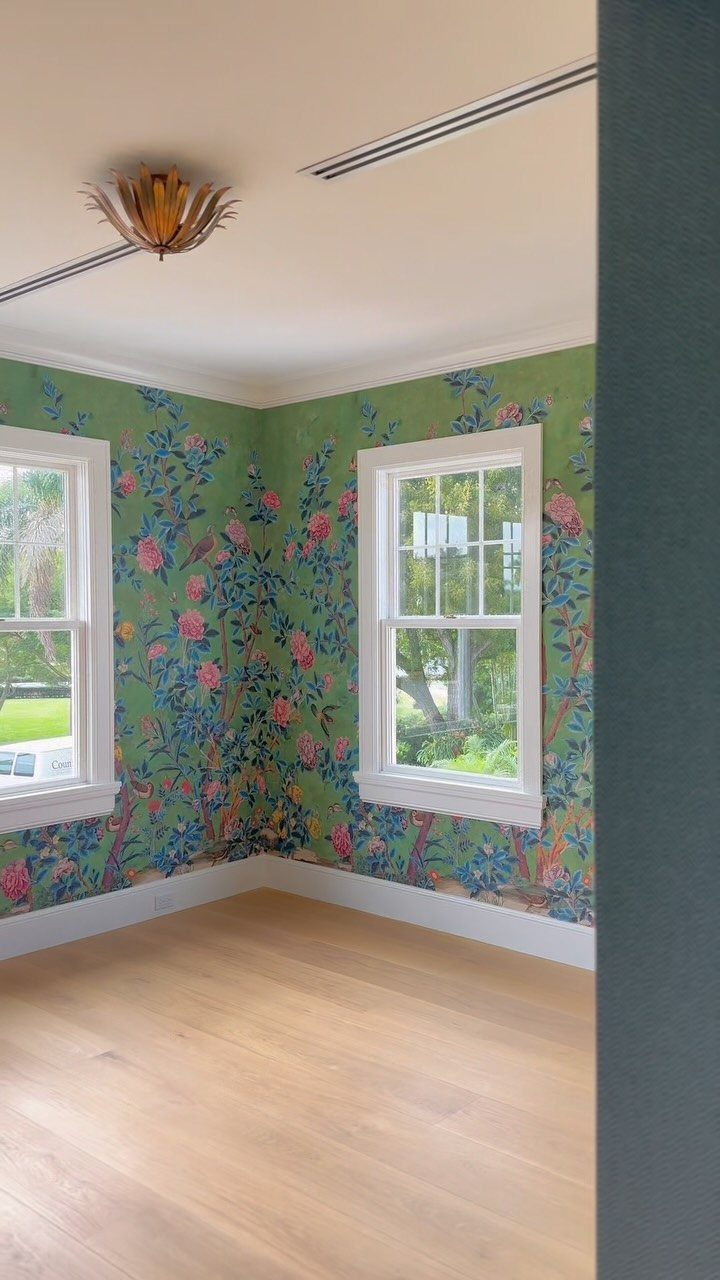 11 Green Painted Dining Room Ideas with Photos 2 Green floral wallpaper on walls of an empty room with light wood floors.