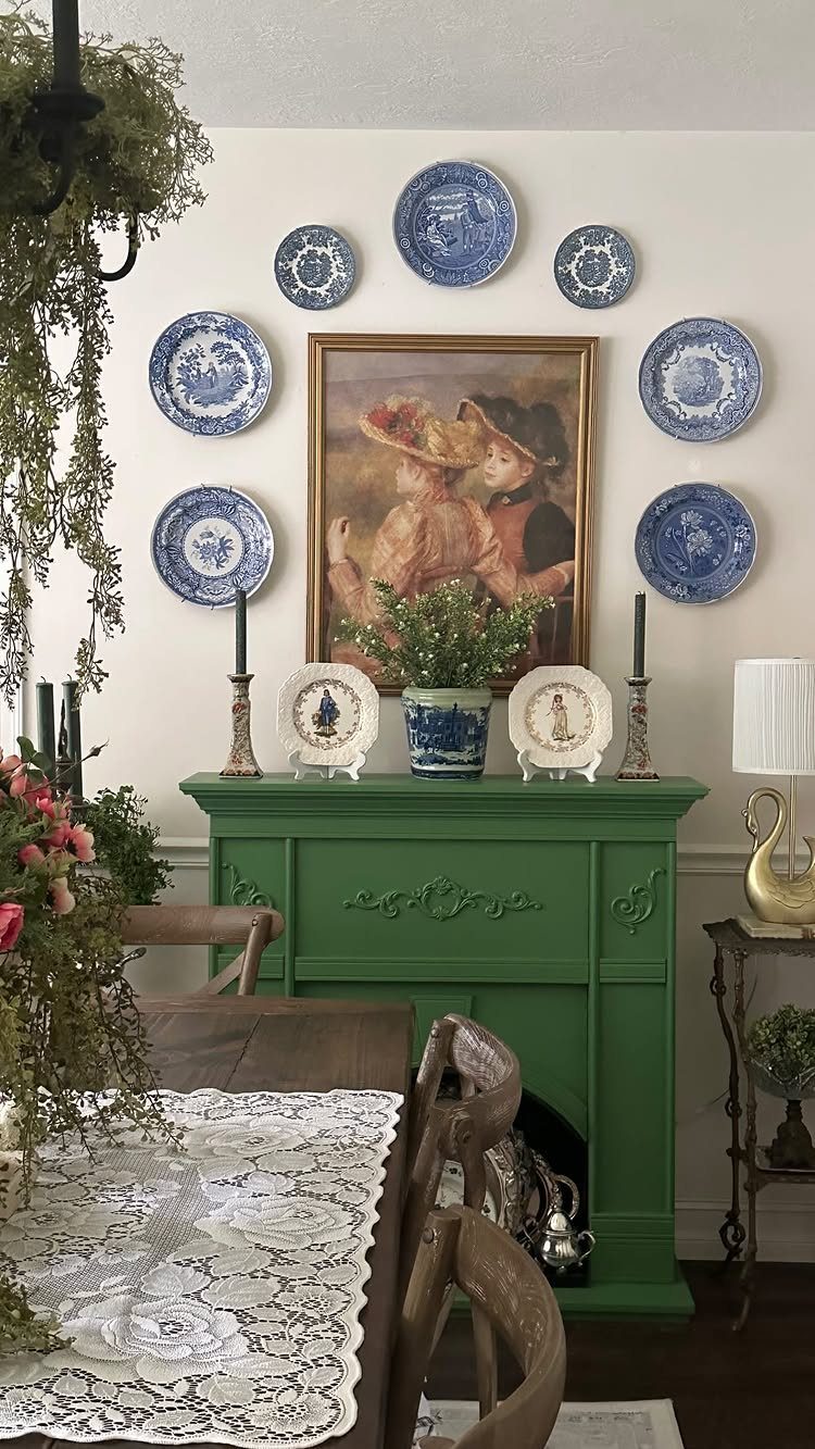 11 Green Painted Dining Room Ideas with Photos 7 Green painted fireplace mantel with blue and white plates and a painting above.