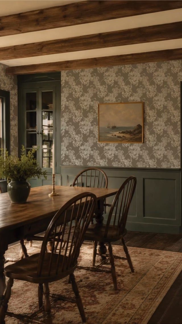 11 Green Painted Dining Room Ideas with Photos 4 Wooden dining table and chairs in a room with green wainscoting and beams.