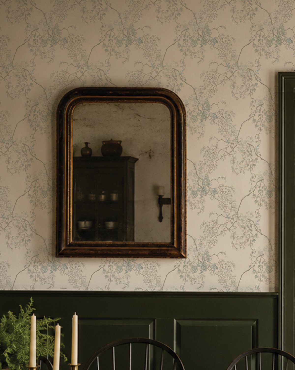 9 Green Walls for Dining Room Ideas with Photos 4 Dark green wainscoting and floral wallpaper with a gold-framed mirror in a dining area.