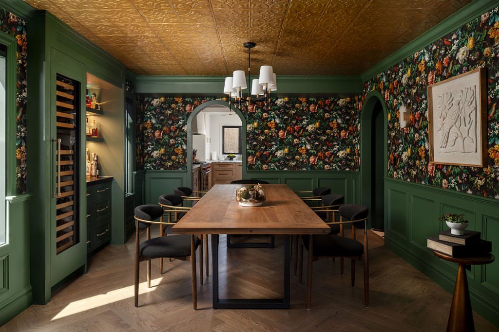 9 Green Walls for Dining Room Ideas with Photos 9 Natural wood dining table in a room with dark green walls and floral wallpaper.