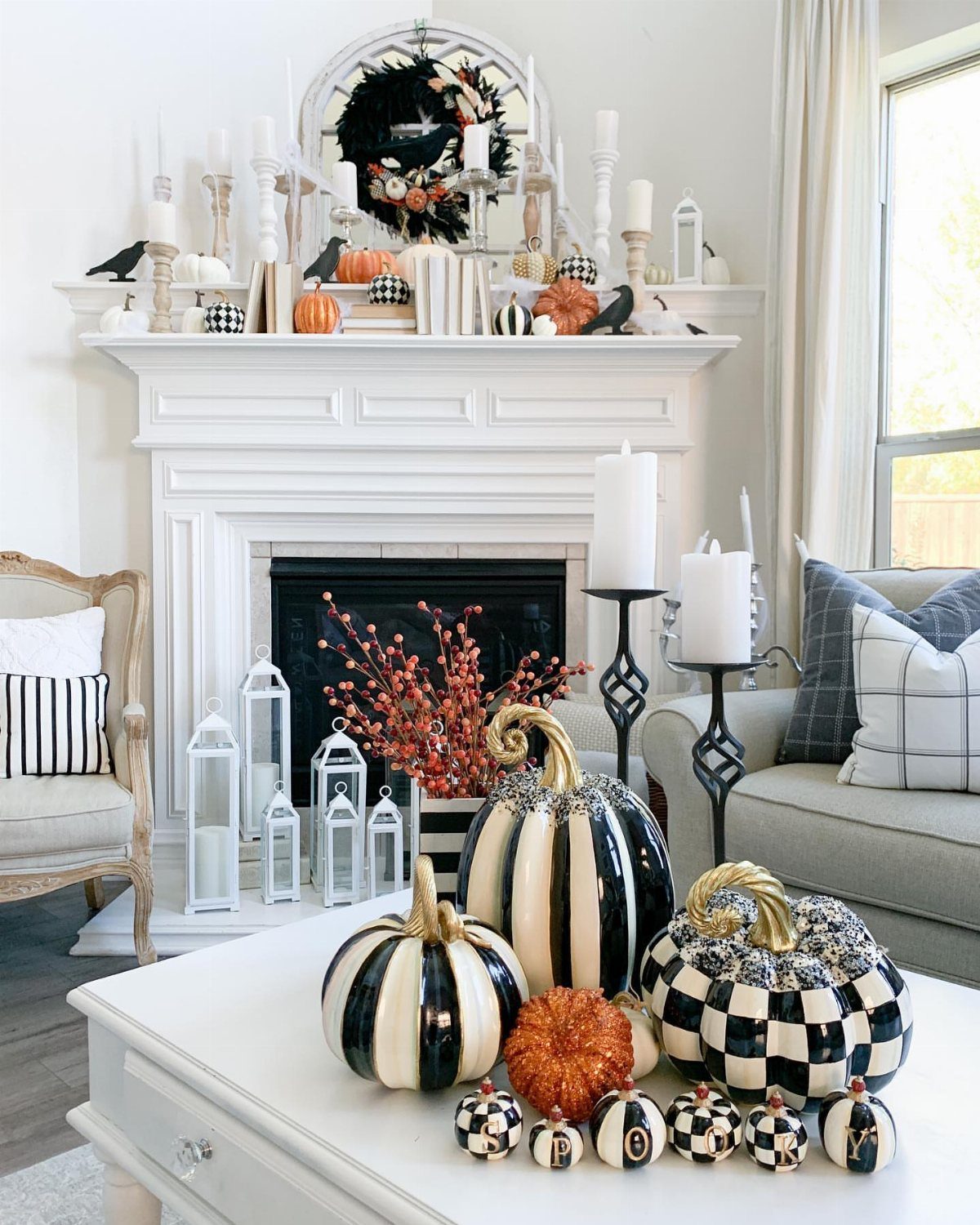 16 Halloween Room Decor Ideas to Set the Scene 2 Black and white striped and checkered pumpkins on a white coffee table.