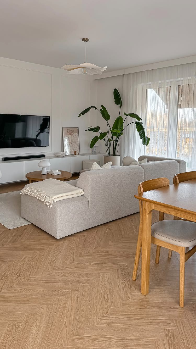 11 Living Dining Room Combo Ideas for Small Spaces 1 Light grey sofa and wooden dining set in a bright, neutral-toned open living space.