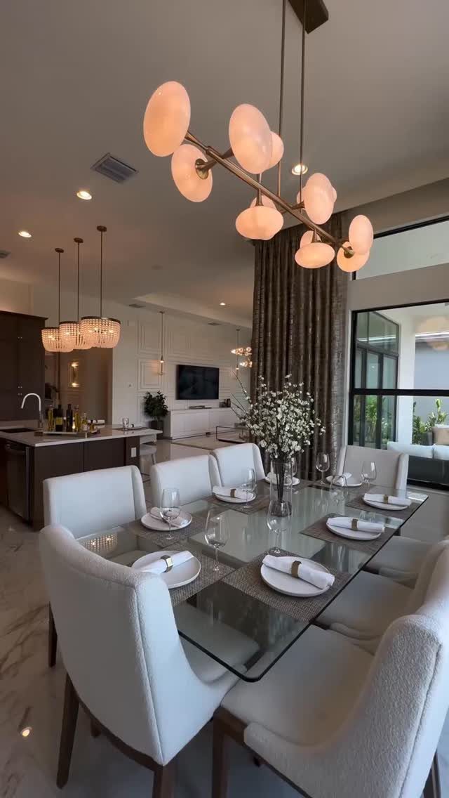11 Living Dining Room Combo Ideas for Small Spaces 10 Modern open-concept living and dining room with white chairs and a glass table.