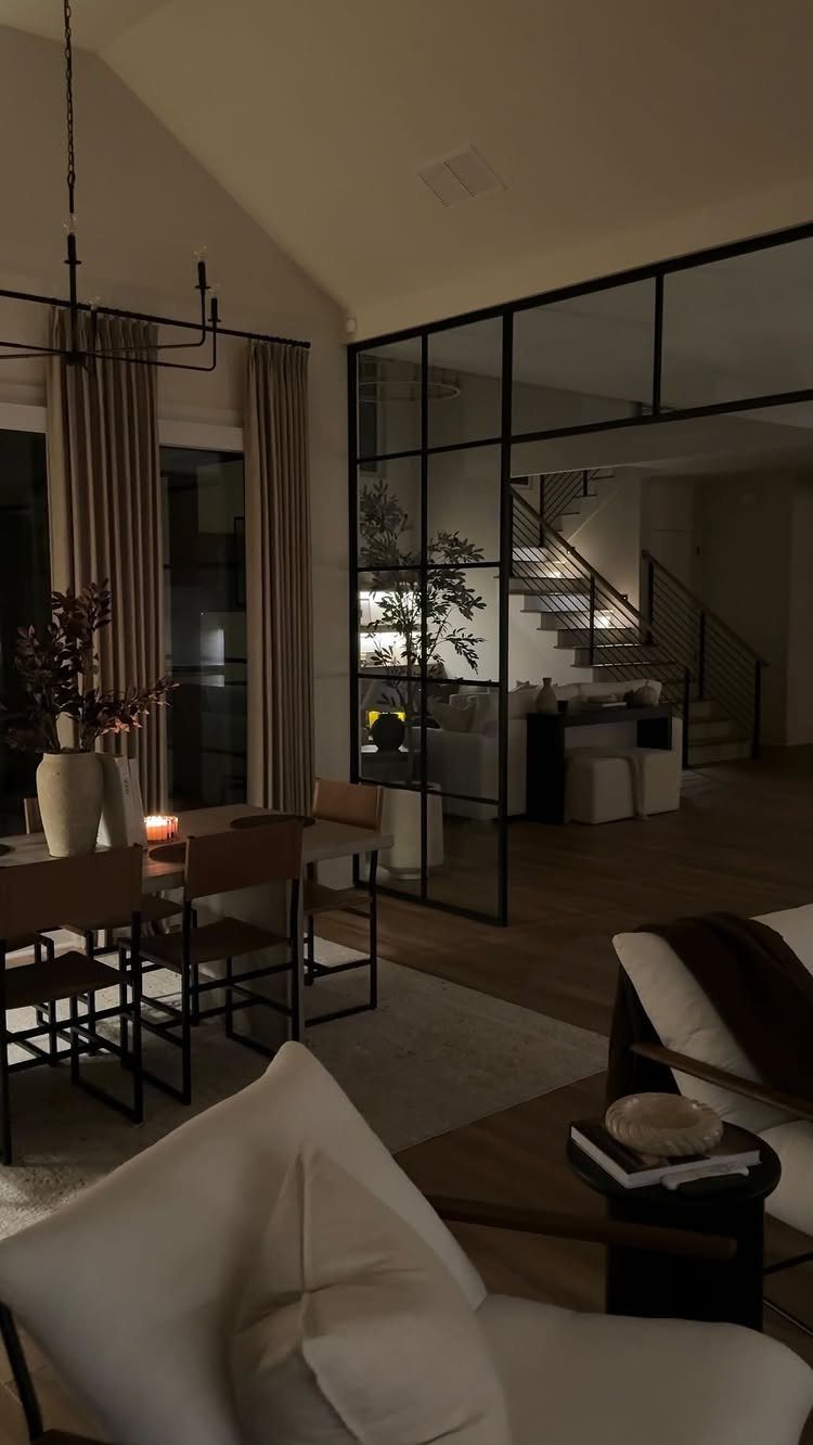 11 Living Dining Room Combo Ideas for Small Spaces 4 Dining area with black chandelier and glass wall separating it from living room