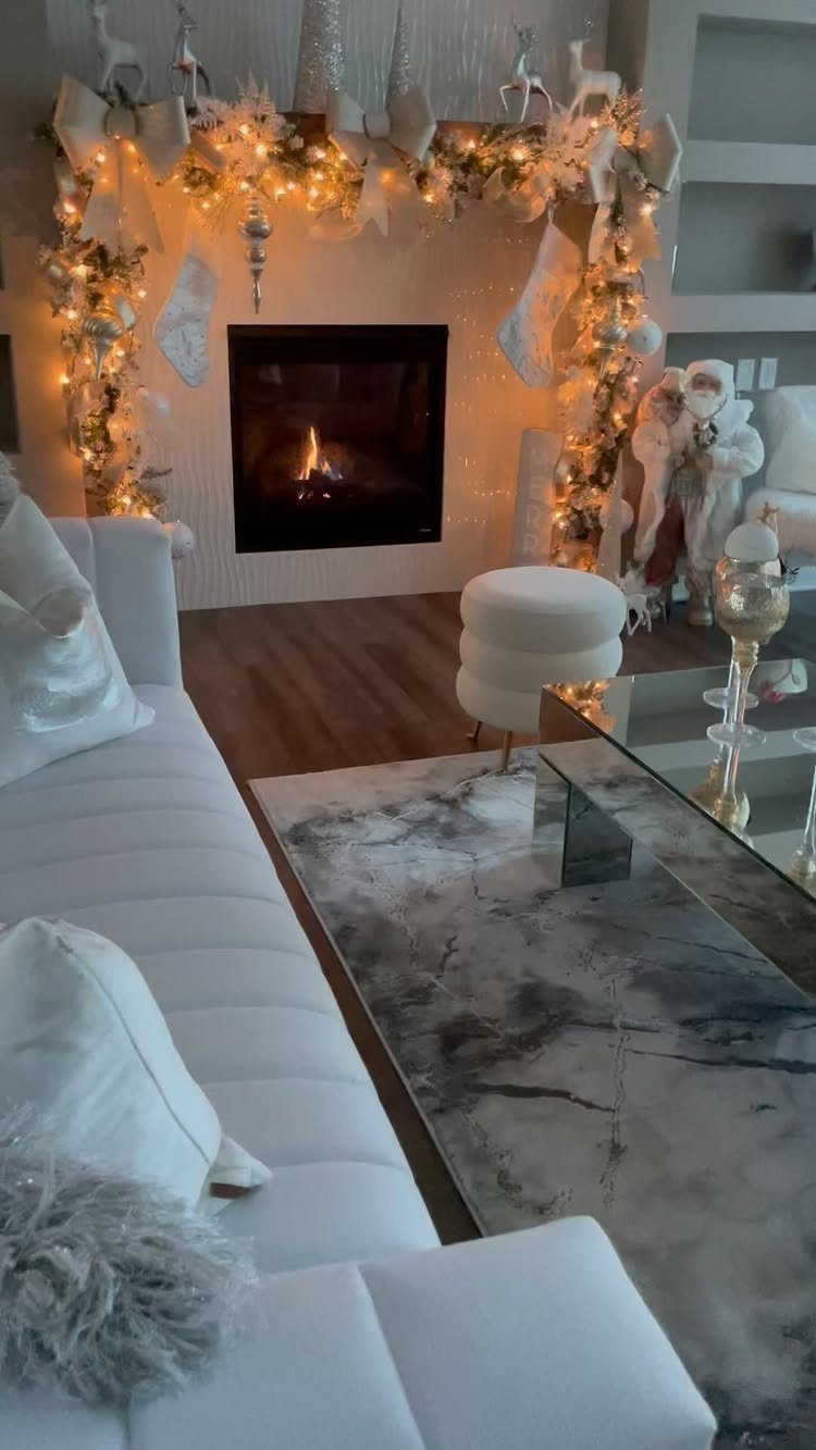 14 Modern Christmas Living Room Ideas with Photos 12 Modern living room with a white sofa and a festive, lit-up fireplace mantel.