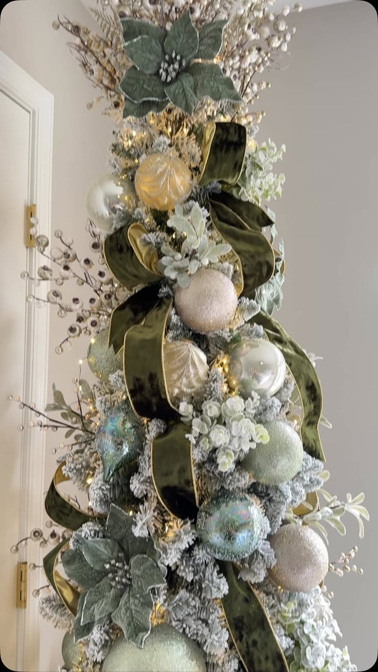 14 Modern Christmas Living Room Ideas with Photos 7 Flocked Christmas tree with frosted greenery, white snow, and olive green velvet ribbons