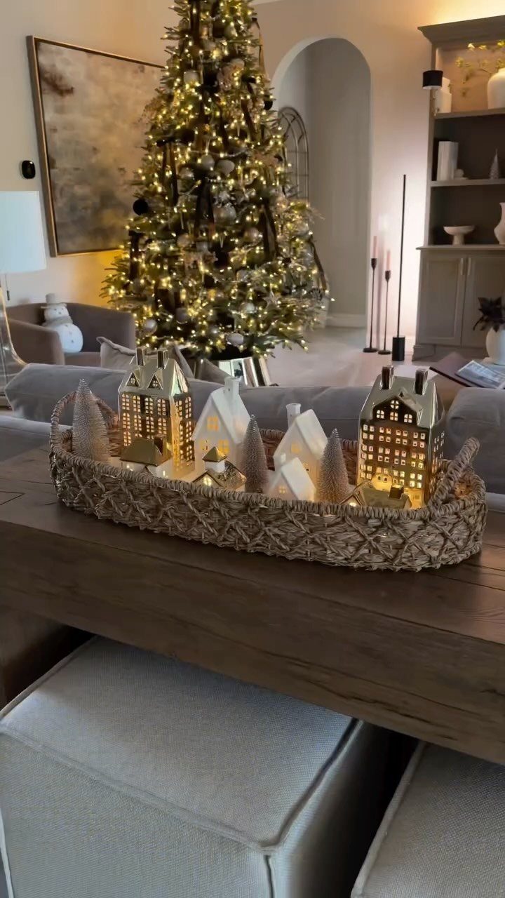 14 Modern Christmas Living Room Ideas with Photos 1 Illuminated ceramic Christmas village in a woven tray on a wooden table