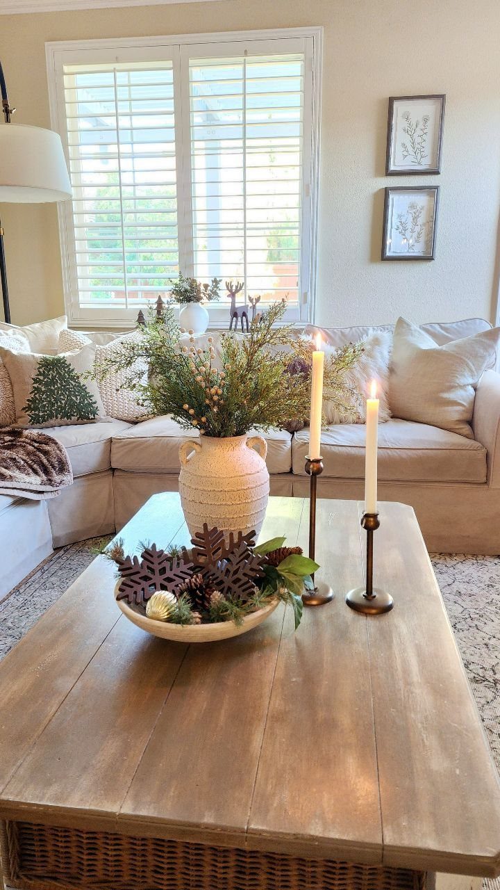 14 Modern Christmas Living Room Ideas with Photos 4 Wooden coffee table with pinecones and white taper candles in a living room