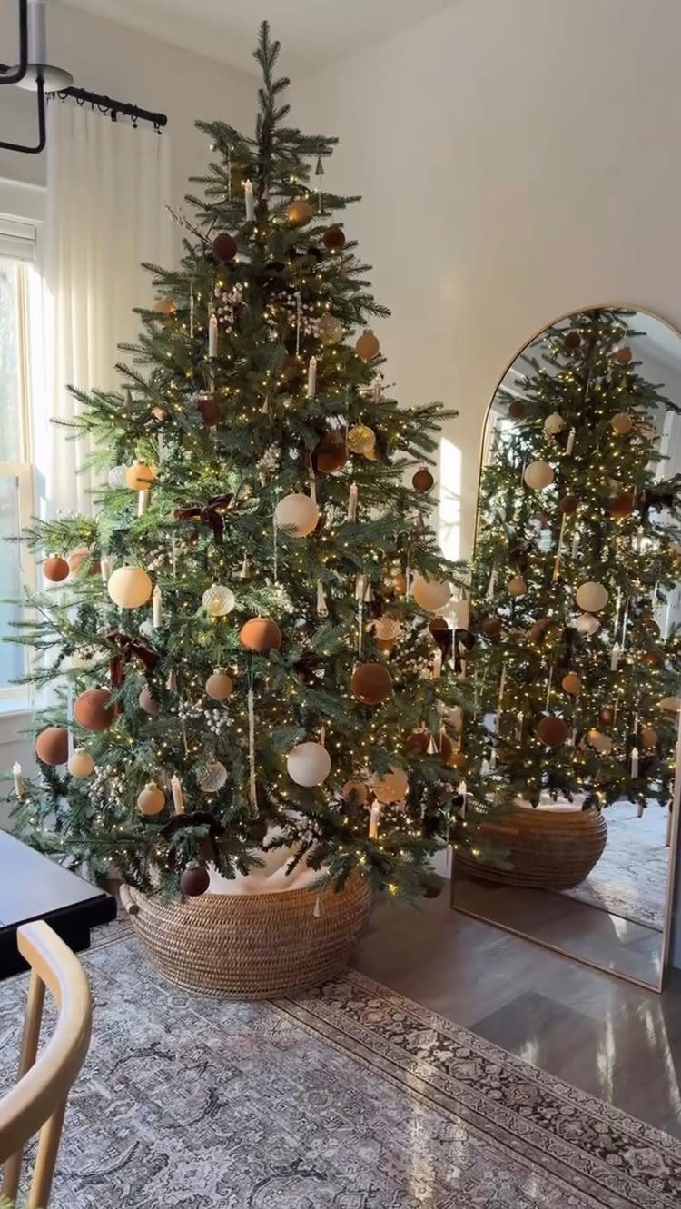 14 Modern Christmas Living Room Ideas with Photos 8 Decorated Christmas tree in a woven basket placed next to a bright window.