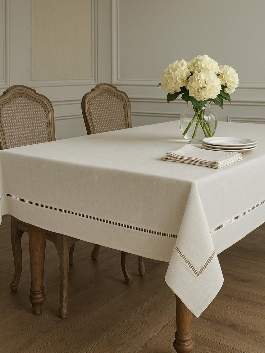 13 Modern Elegant Dining Room Ideas with Photos 5 White linen tablecloth with decorative border on a dining table with white hydrangeas.