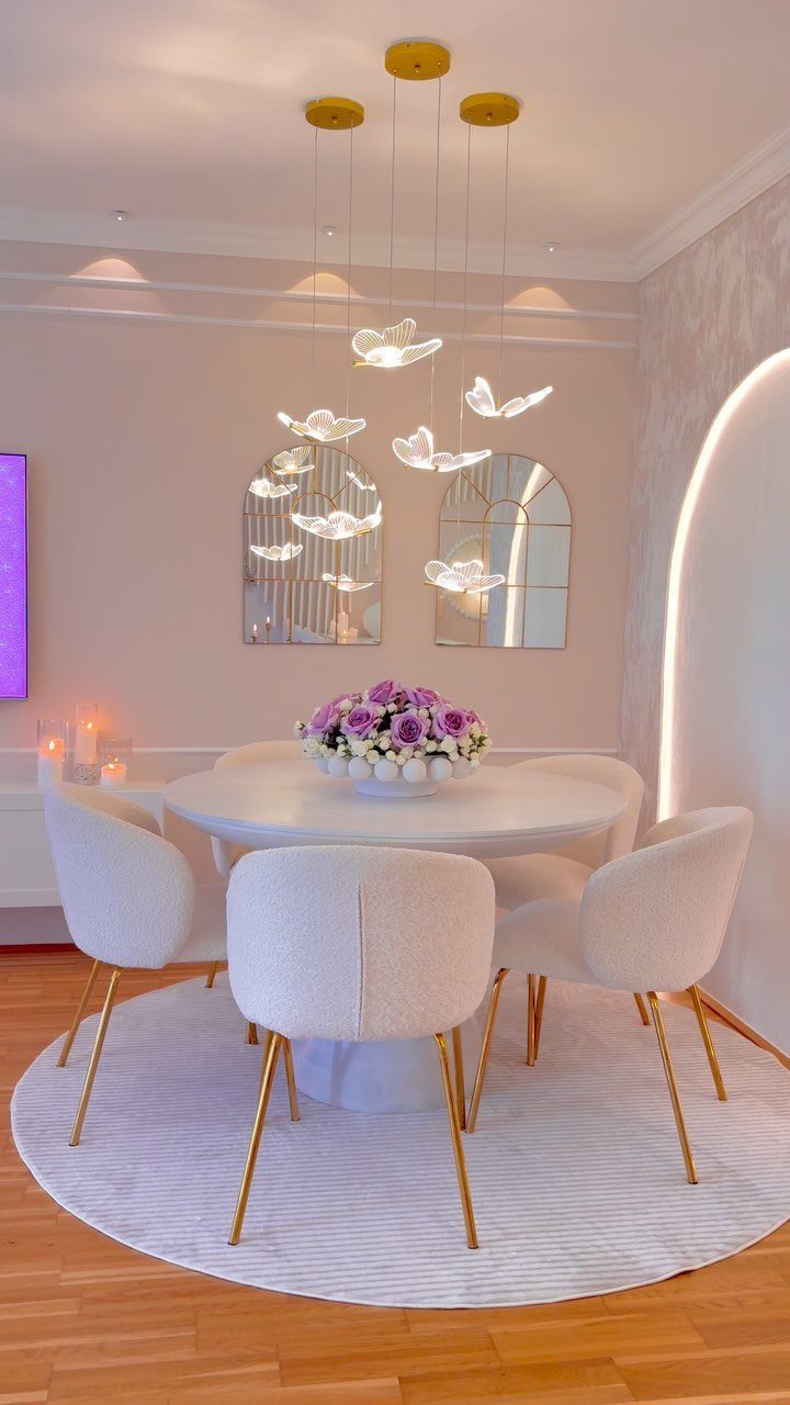 13 Modern Elegant Dining Room Ideas with Photos 10 White round dining table and gold-legged chairs under a sculptural gold pendant light.