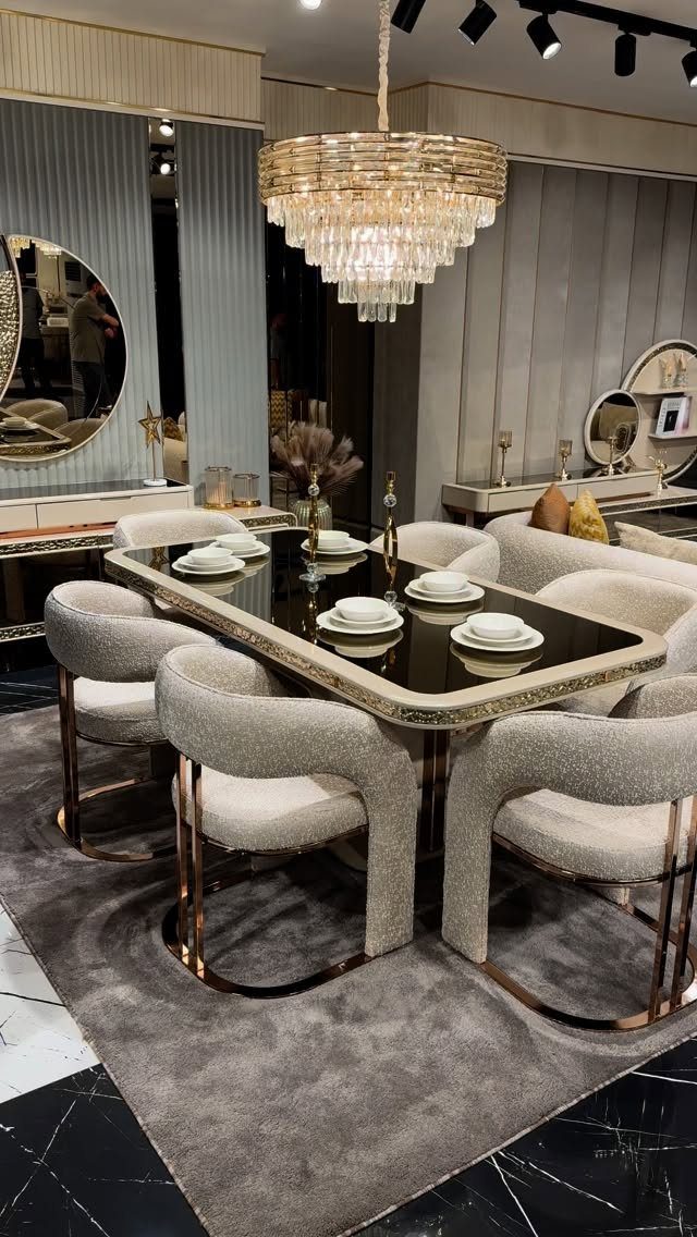 13 Modern Elegant Dining Room Ideas with Photos 4 Tiered crystal chandelier hanging over a black marble dining table with beige chairs.