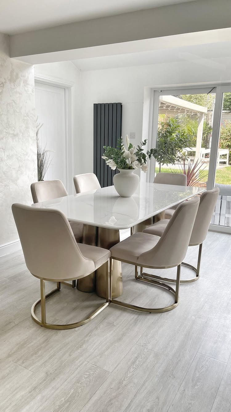 13 Modern Elegant Dining Room Ideas with Photos 3 Rectangular white marble dining table with beige sculpted chairs and gold metal bases.