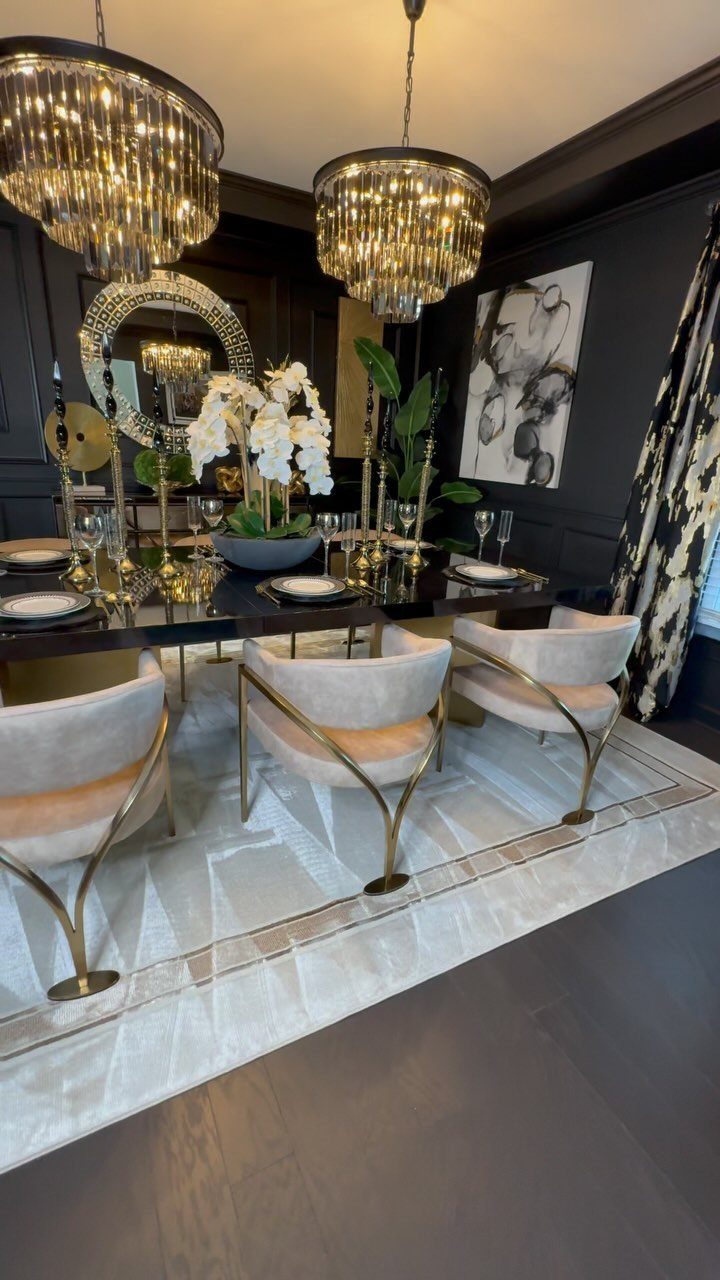 13 Modern Elegant Dining Room Ideas with Photos 2 Elegant dining room with gold chairs and a geometric rug under a black table.
