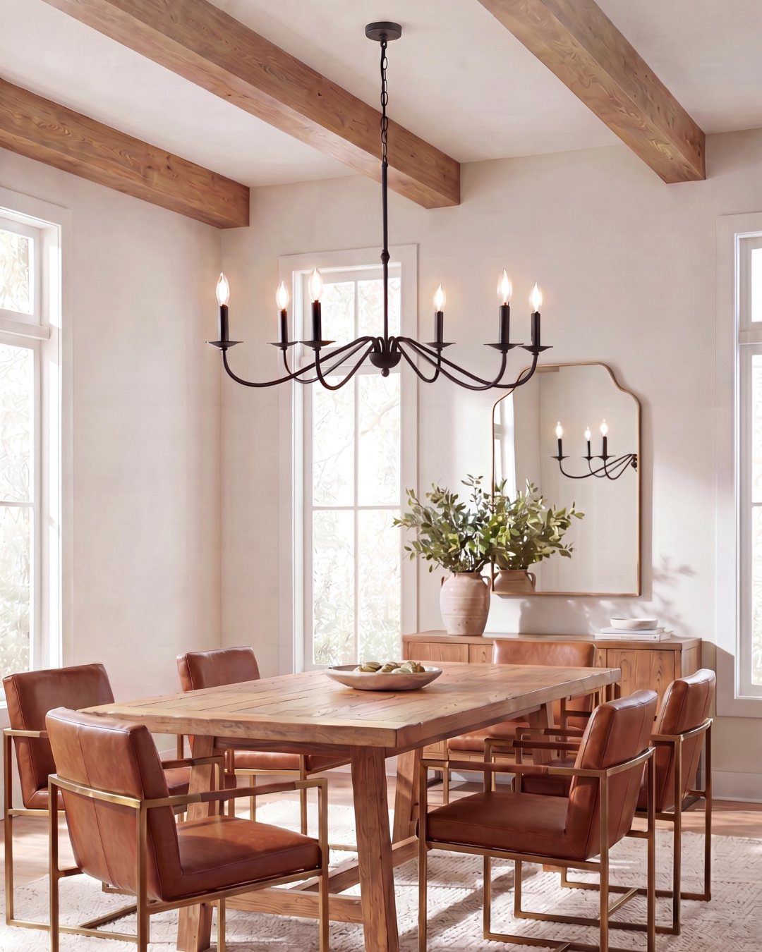 14 Modern Farmhouse Dining Room Ideas with Style 3 Dining room with neutral tones, wooden table, leather chairs, and exposed ceiling beams.