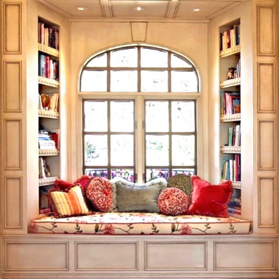 14 Modern Farmhouse Dining Room Ideas with Style 6 Built-in window seat nook with colorful pillows and flanking recessed bookshelves.