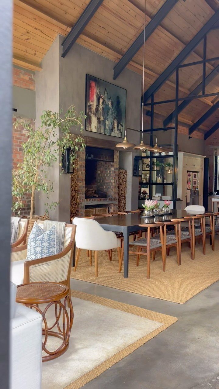 23 Modern Luxury Dining Room Ideas with Photos 11 Dining room with black steel beams, wood ceiling, and a long dark wooden table.