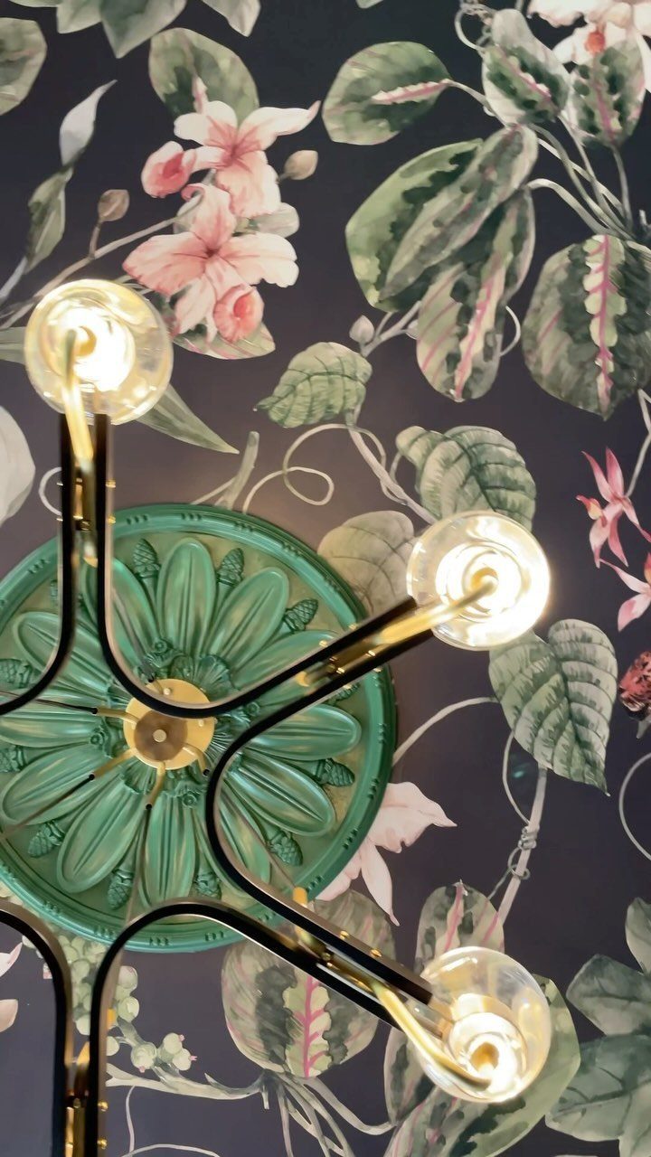 23 Modern Luxury Dining Room Ideas with Photos 14 Botanical patterned wallpaper with pink flowers and a gold light fixture.